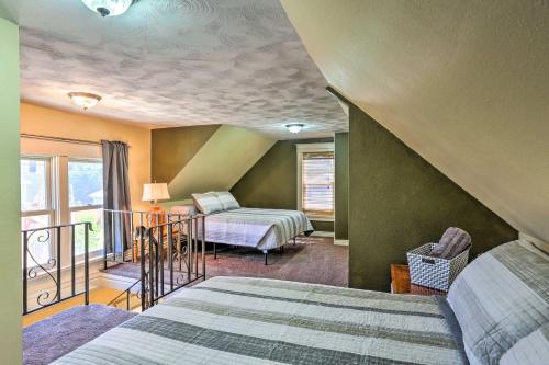 a bedroom with two beds and a balcony at Walk to Dtwn Historic Gem with Deck in Rapid City in Rapid City