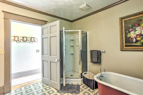 a bathroom with a tub and a glass shower at Walk to Dtwn Historic Gem with Deck in Rapid City in Rapid City