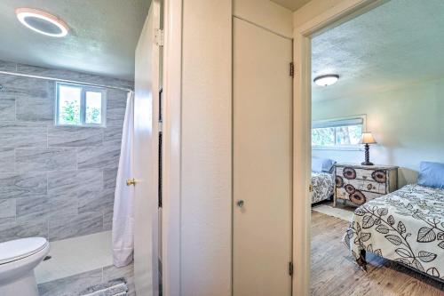 a bathroom with a shower and a toilet and a bed at Modern Cortez Mountain Retreat with Yard and View in Cortez