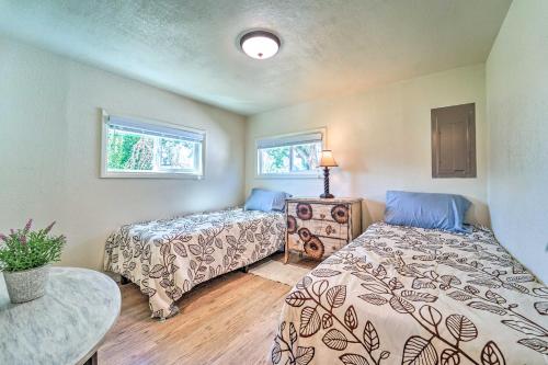 a bedroom with two beds and a table and two windows at Modern Cortez Mountain Retreat with Yard and View in Cortez