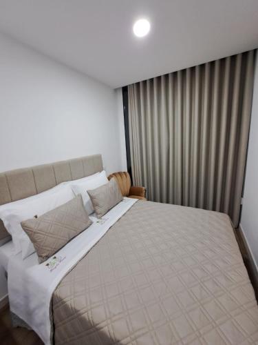 a bedroom with a large bed with white sheets and pillows at Bicycle House in Felgueiras