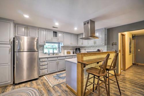 a kitchen with white cabinets and a stainless steel refrigerator at Updated Buckeye Lake Retreat with Game Room! in Thornville