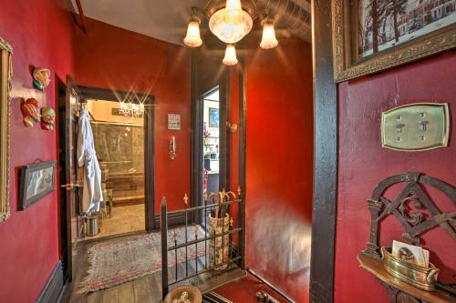 a red hallway with a red wall and a doorway at Vintage Apartment in Historic Downtown La Porte! in LaPorte