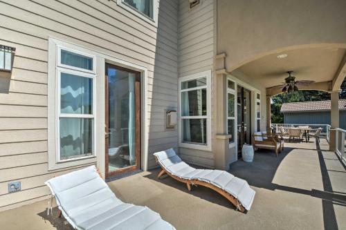 a porch with white chairs on a house at Luxe Getaway with Riverfront Views in Grants Pass! in Grants Pass