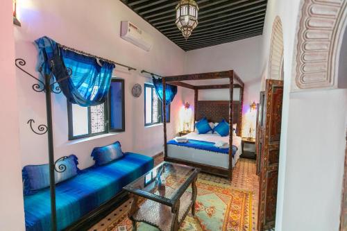 a bedroom with two beds and a mirror at Dar Hafsa in Fès