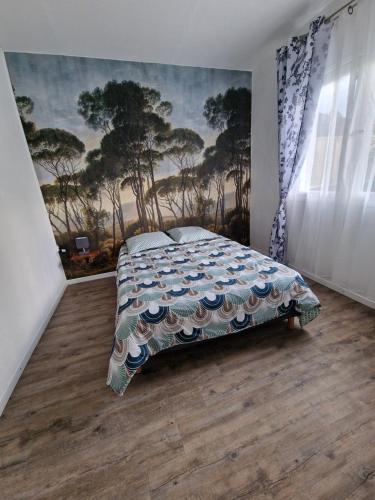 1 dormitorio con 1 cama y una pintura en la pared en Le Saint Trosepez, en Sainte-Rose