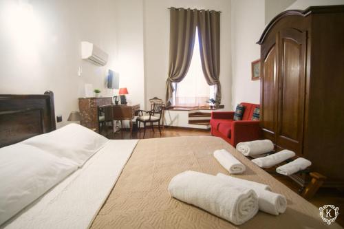a bedroom with a large bed with towels on it at Residenza Kastrum in Cagliari