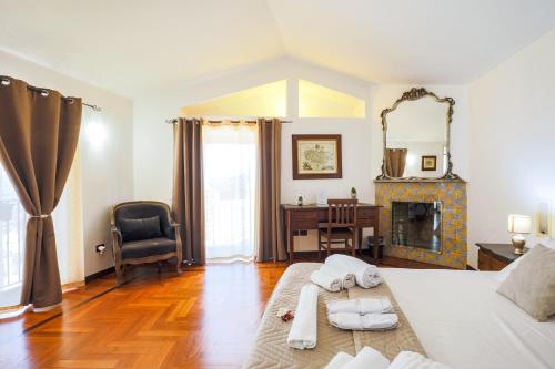 a bedroom with a bed and a desk and a fireplace at Residenza Kastrum in Cagliari