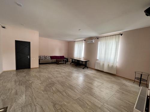 an empty room with a couch and a table at Laguna House next to Pool at Bazaleti Lake in Bazalet'i
