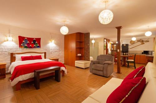 a bedroom with a bed and a living room at La Floresta Hotel in Baños