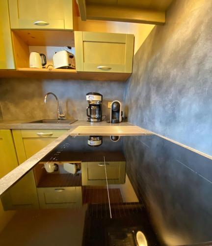 a kitchen with a sink and a coffee maker on a counter at Appartamento Toilà in Livigno