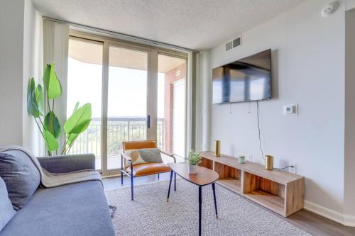a living room with a couch and a table at Exclusive Apt in Ballston with Gym in Arlington