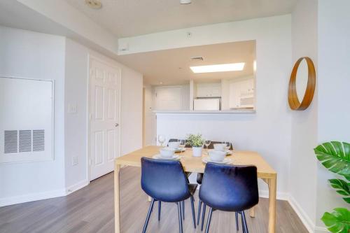 a dining room with a table and two blue chairs at Exclusive Apt in Ballston with Gym in Arlington