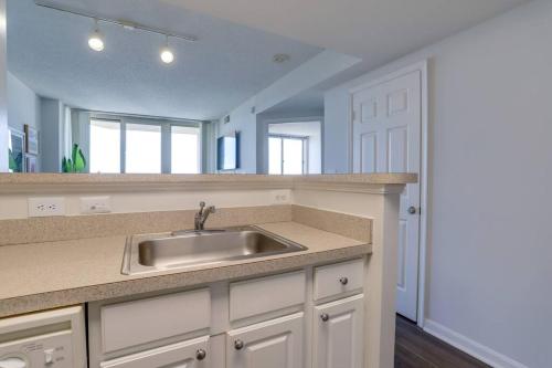a kitchen with a sink and a mirror at Amazing 1 Bedroom Condo At Ballston With Gym in Arlington