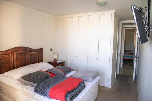 a bedroom with a bed with two pillows on it at Piso 2 2d2b vista al mar frontal in Coquimbo