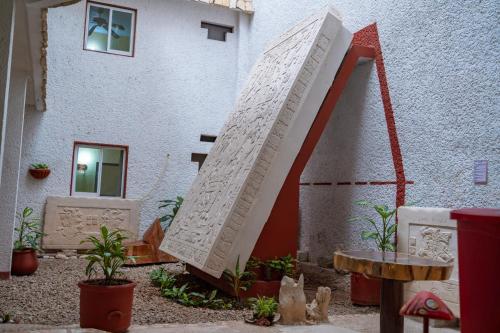 a sculpture of a staircase in front of a building at Hotel - Museo Xibalba in Palenque