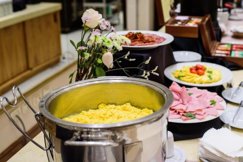 a table with plates of food and a pot of food at Lagos Del Calafate in El Calafate