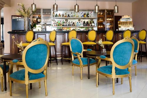 a restaurant with blue and yellow chairs and tables at Lagos Del Calafate in El Calafate