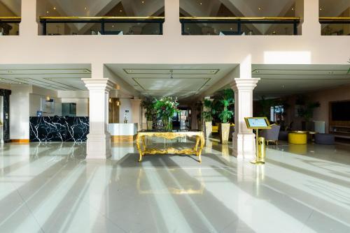 a lobby with a gold bench in the middle of a building at Lagos Del Calafate in El Calafate