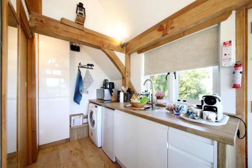 a kitchen with a washer and dryer in a house at Observatory at South Downs Stay in Houghton