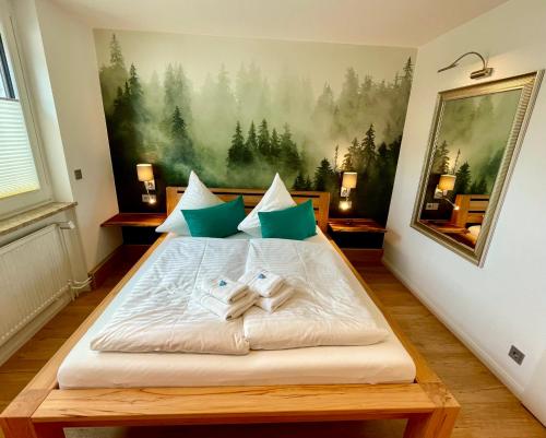 a bedroom with a bed with two towels on it at Ferienwohnung Harzurlaub in Hahnenklee-Bockswiese