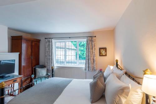 a hotel room with a bed and a window at Spread Eagle Inn in Stourton