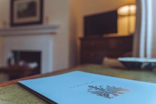 a blue sign sitting on top of a table at Spread Eagle Inn in Stourton