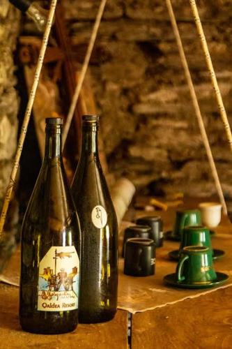 two bottles sitting on top of a wooden table at Qaldea Resort in Ushguli