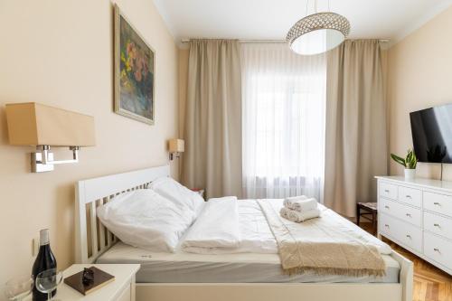 a bedroom with a white bed and a window at P&O Serviced Apartments Plac Konstytucji in Warsaw