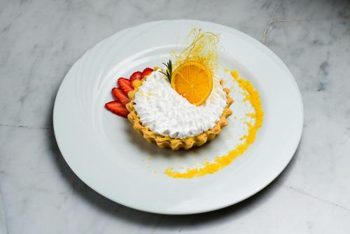 a white plate with a pie with an orange on it at Lagos Del Calafate in El Calafate