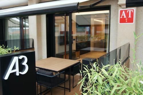 a table and chairs in front of a building at Loft Mardevela in Sanxenxo