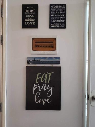 a chalkboard with the words eat pray love on a wall at SMDC Light Residences Condominium in Manila