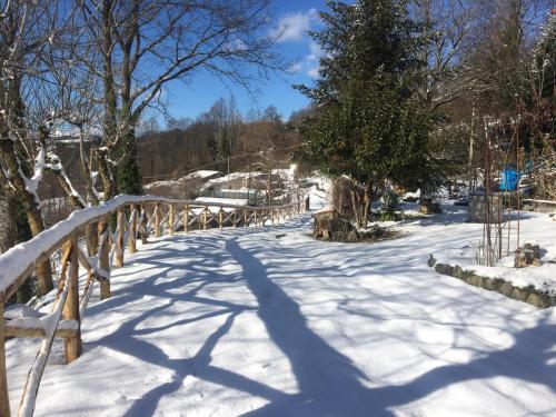 a snow covered path with a wooden bridge at Villa Franca in Castelluccio Inferiore