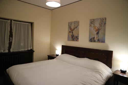 a bedroom with a bed and two paintings on the wall at Cesana Pearl in Cesana Torinese