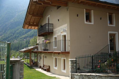 a large building with balconies and a bench in front at bnb Uja in Balme