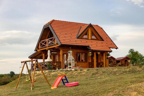a house on a hill with a playground at Hižica Bubika in Karlovac