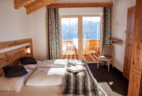 a bedroom with two beds and a window at Apart Sattelkopf in Fiss