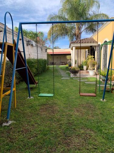 a playground with swings in the yard of a house at Estancia Santa Fe in Celaya
