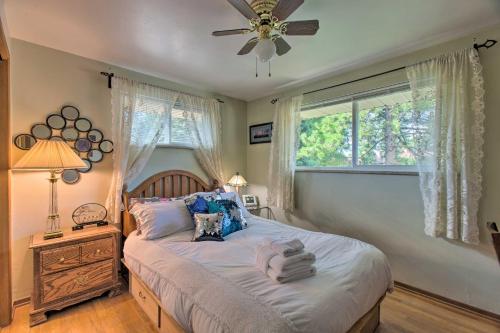 a bedroom with a bed with a ceiling fan and a window at Private Lake Home with Large Yard in Denver! in Denver