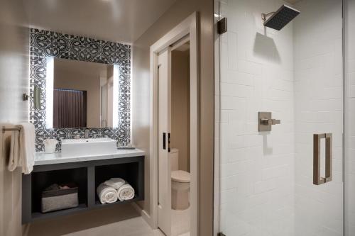 a bathroom with a sink and a toilet and a mirror at The Piccolo in Paso Robles