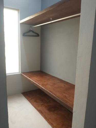 a shelf in a room with a window at Casa Nicte-ha Valladolid in Valladolid