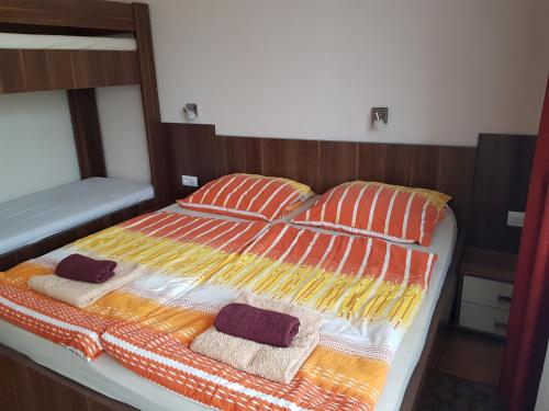 a bed with two pillows on top of it at Fridrich apartman in Veľký Meder