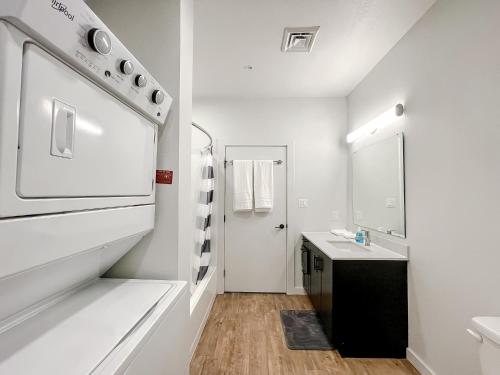 a white bathroom with a sink and a stove at Sleepover 1BD 1BA Downtown Bowling Green Apartments in Bowling Green