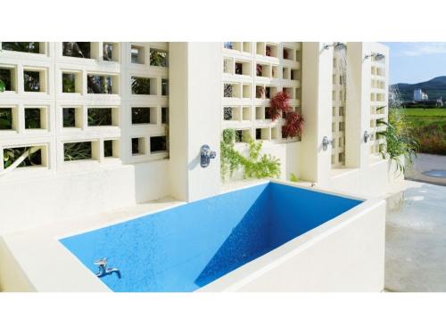 a swimming pool in the middle of a building at Bears Stay Kumejima Eef Beach - Vacation STAY 85666v in Kumejima
