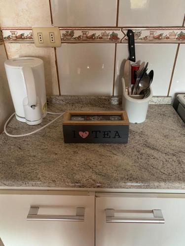 a kitchen counter with a tea box on it at Cabañas Bosque Sur in Puerto Varas