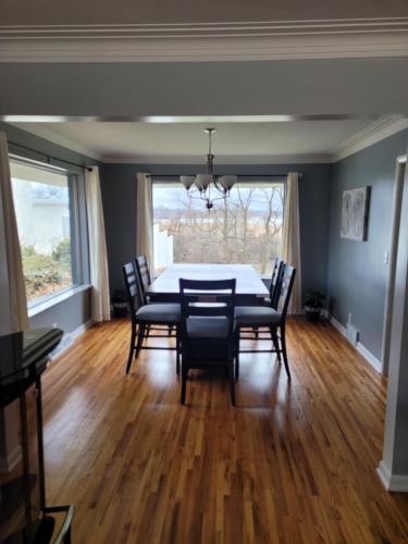 a dining room with a table and chairs at dock, game room, bar and private river view patio in Toledo