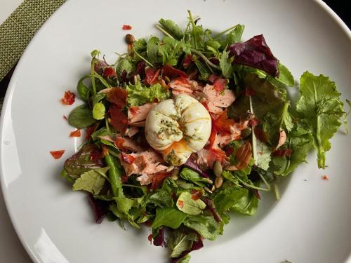 a salad on a white plate on a table at La Colmena eco lodge in Ensenada