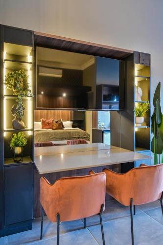 a bedroom with a bed and a table and chairs at Summer PALACE Guesthouse in Bloemfontein