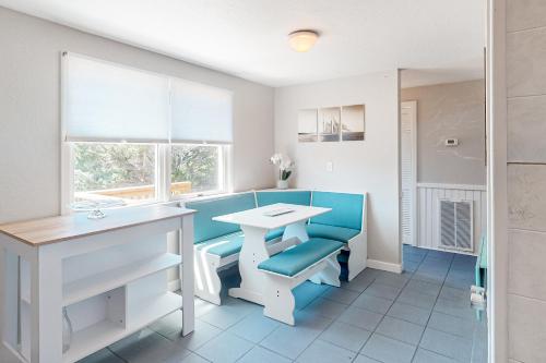 a bathroom with a white table and a blue bench at Piper's Nest AV927 in Avon