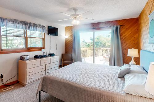 a bedroom with a bed and a sliding glass door at Piper's Nest AV927 in Avon